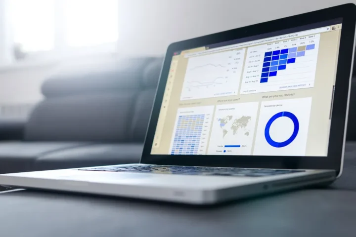 laptop with analytics dashboard charts and widgets