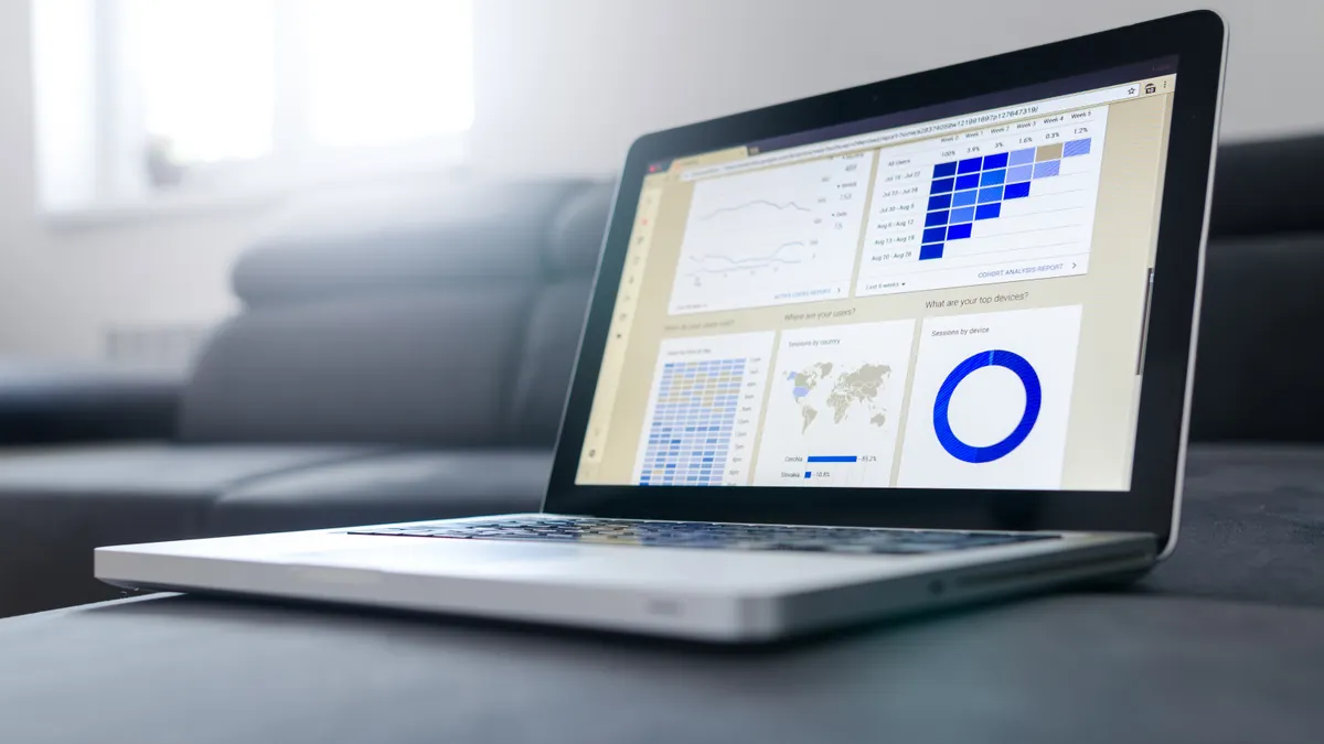 laptop with analytics dashboard charts and widgets