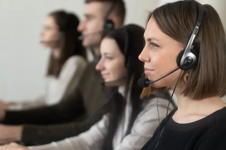 call center team wearing headsets at computers