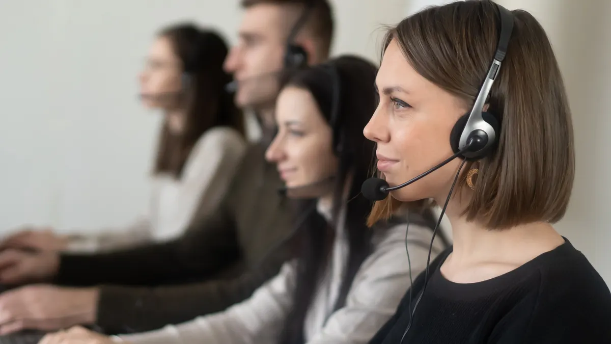 call center team wearing headsets at computers