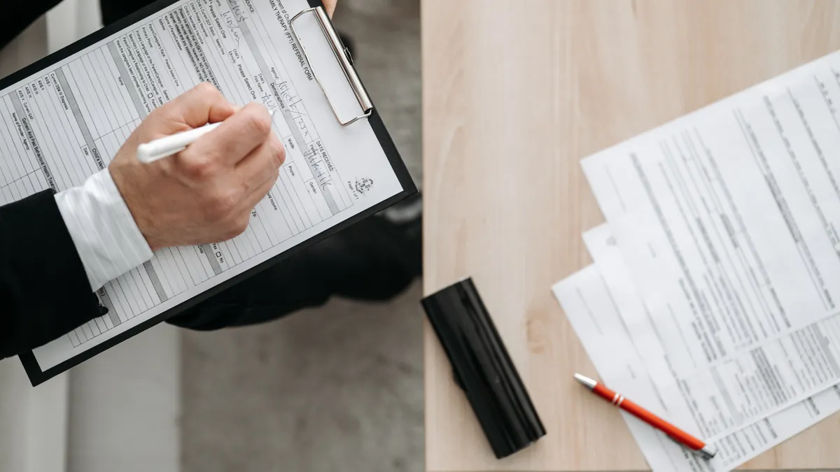 How to build a SaaS intake form that reduces bad purchases person filling out paperwork on a clipboard