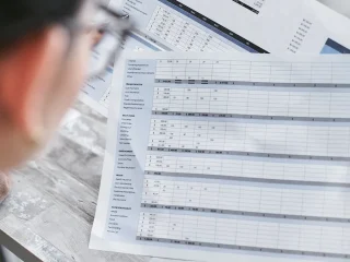 person reviewing a spreadsheet with multiple rows and columns