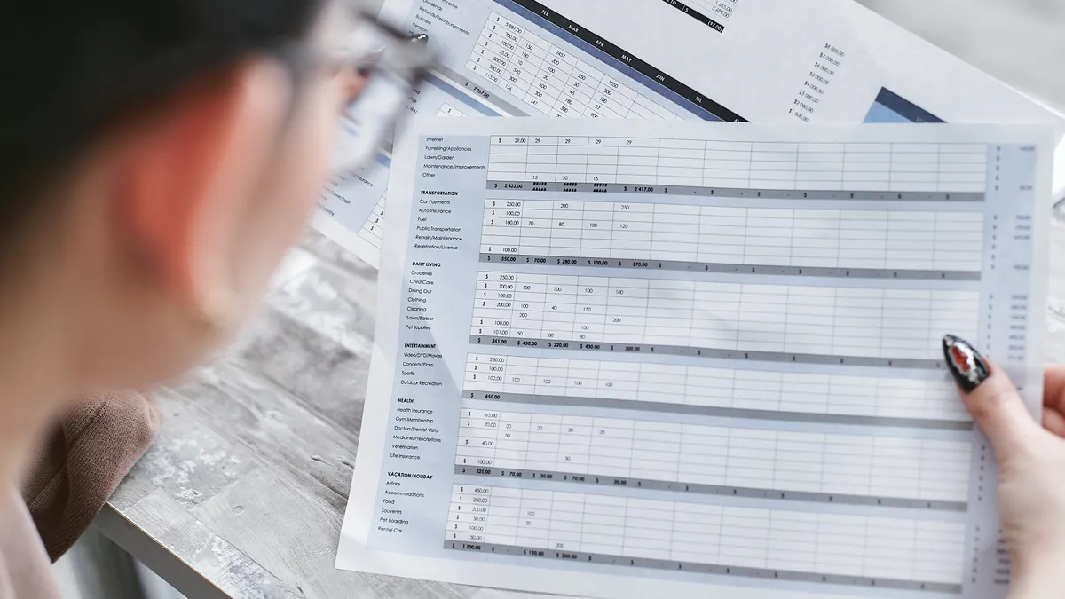 person reviewing a spreadsheet with multiple rows and columns
