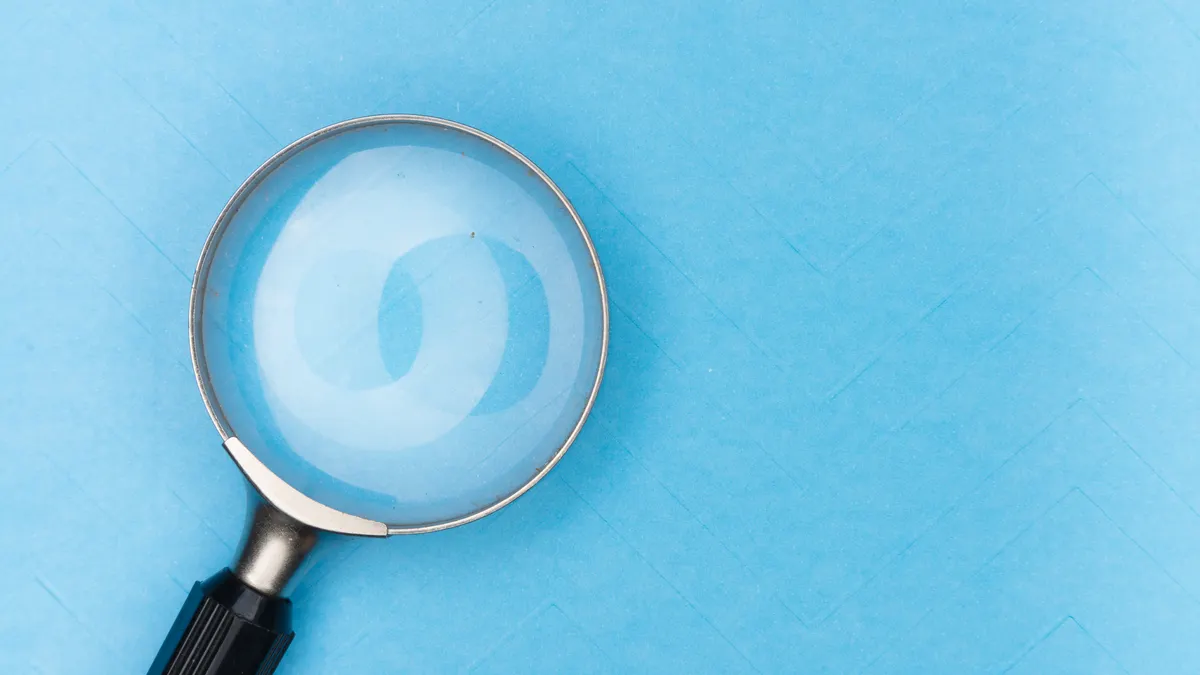 How to compare SaaS security claims during research Magnifying glass on blue background, symbolizing close review