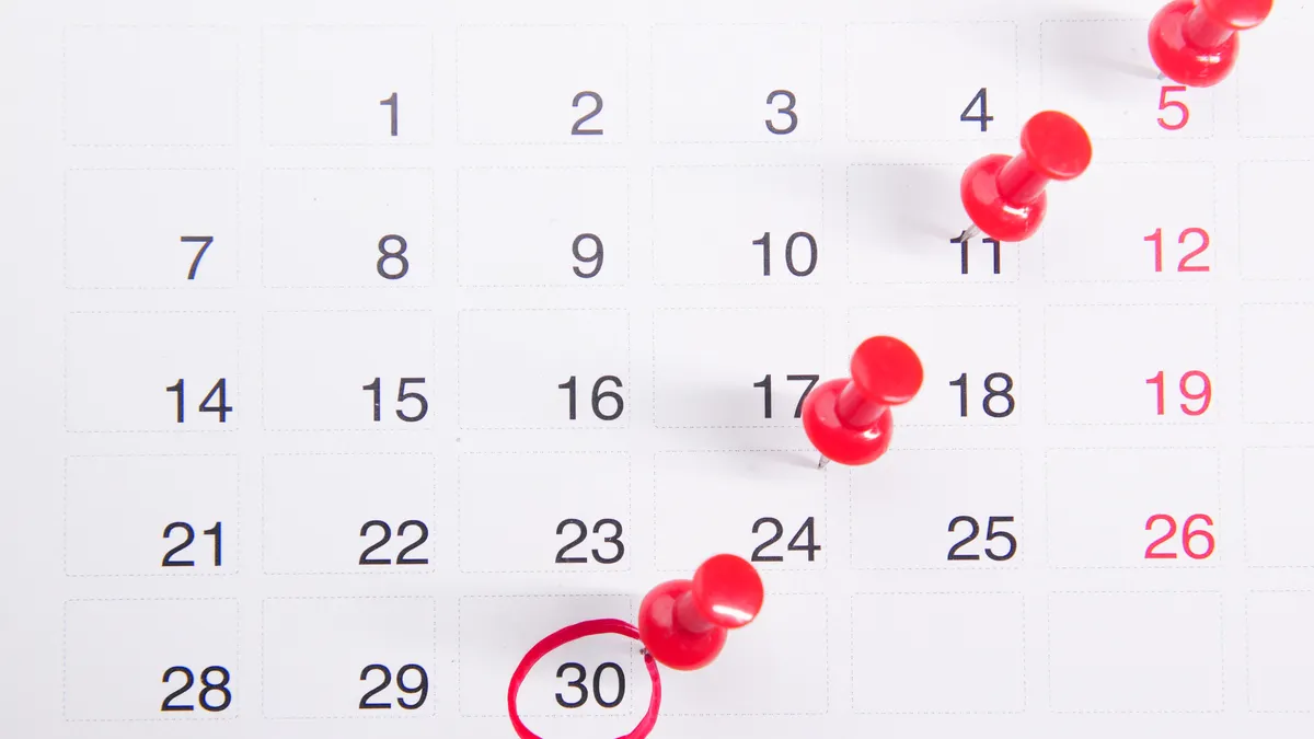 Monthly calendar with red pins marking important dates