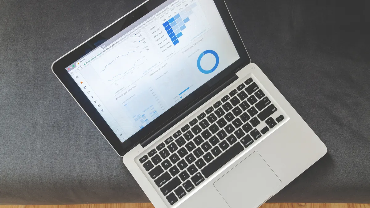 Laptop showing analytics dashboard with charts